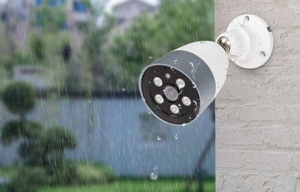 Outdoor security camera mounted beside a window.